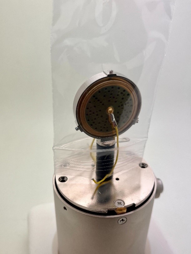 Capsule covered with a protective zip bag during soldering to prevent flux or solder residue from reaching the diaphragm.
