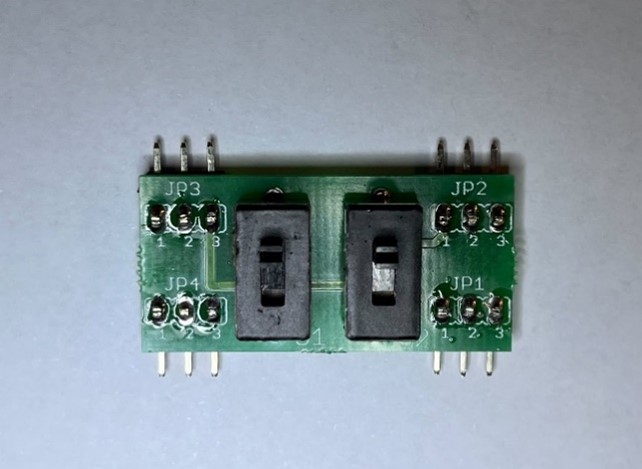 Switch sub-PCB front side showing two slide switches and four 3-pin headers (JP1–JP4) installed.