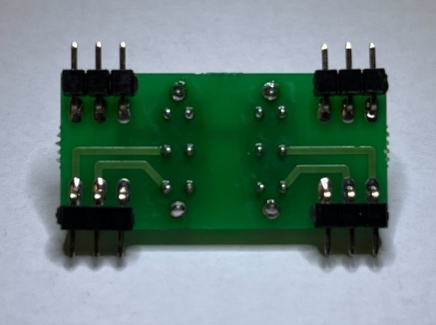 Switch sub-PCB solder side showing the header pins and switch legs after soldering.