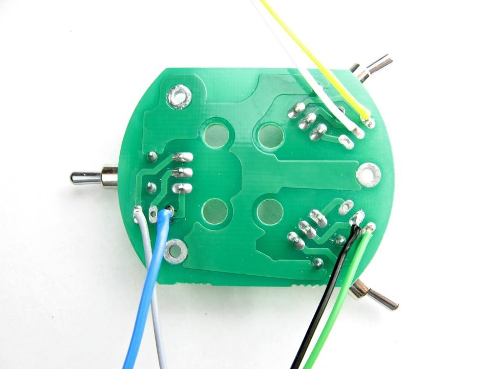 Six different color wires being soldered to capsule connections