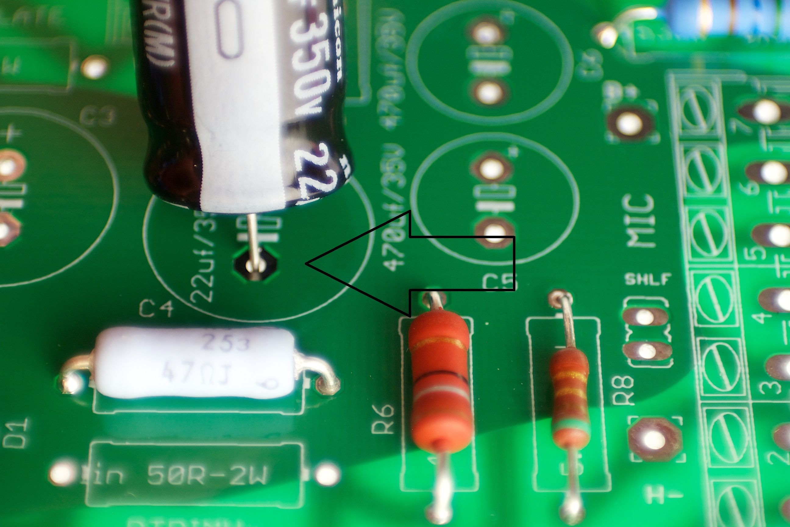 Electrolytic capacitor polarity alignment — white stripe is negative