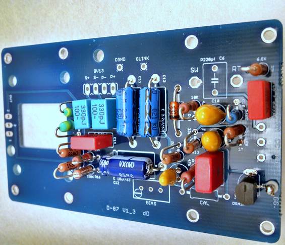 D-87 PCB with all capacitors installed: yellow tantalums, blue electrolytics, red WIMA film caps, and small ceramics.