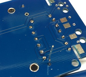 Solder side of main PCB showing trimmed resistor leads and SMD components
