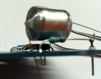 Close-up of the 10,000 pF 630V polystyrene capacitor with its large silver cylindrical body